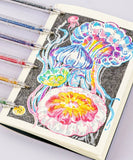 Capped Iridescent Glitter Gel Ink Pen Set Of 12 with colorful jellyfish drawing on notebook page and black background