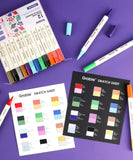 Dual Tone Brush Tip Acrylic Paint Marker Set With Coloring Book showing markers and color swatch sheets on purple background