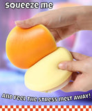 Hands squeezing a soft orange and yellow Grabie Ultimate Stress Relief Squishy to relieve stress and tension