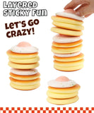 Hand stacking layers of soft pastel squishy discs with speckled topping, Grabie Ultimate Stress Relief Squishy.