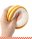Hand squeezing a soft food-themed Grabie Ultimate Stress Relief Squishy for calming sensory fun