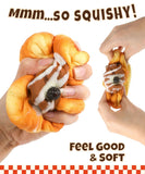 Hands squeezing and stretching a soft dessert-shaped Grabie Ultimate Stress Relief Squishy toy with cream and berry details
