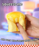 Hand squeezing yellow soft textured Grabie Ultimate Stress Relief Squishy for stress relief and relaxation