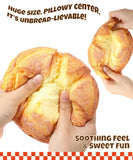 Hands squeezing a realistic bread-shaped Grabie Ultimate Stress Relief Squishy with soft, pillowy texture and fun design