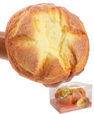 Hand squeezing a soft, yellow bread-shaped Grabie Ultimate Stress Relief Squishy toy with detailed texture and a clear display box below.