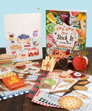 200+ Pages The Flavor Folio Collage Activity Book with colorful food-themed cutouts and scrapbook art supplies on table